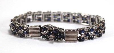 Lot 501 - A white metal articulated link bracelet set...