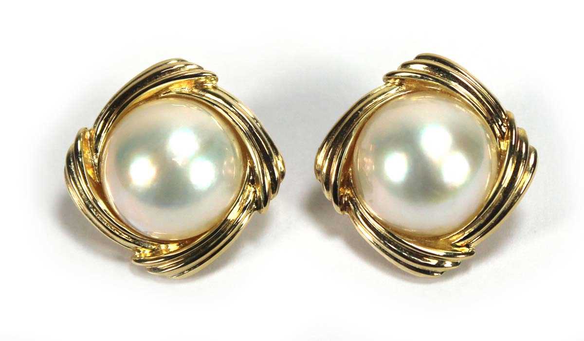 Lot 504 - A pair of 14ct yellow ear clips, each set a...