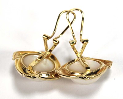 Lot 504 - A pair of 14ct yellow ear clips, each set a...