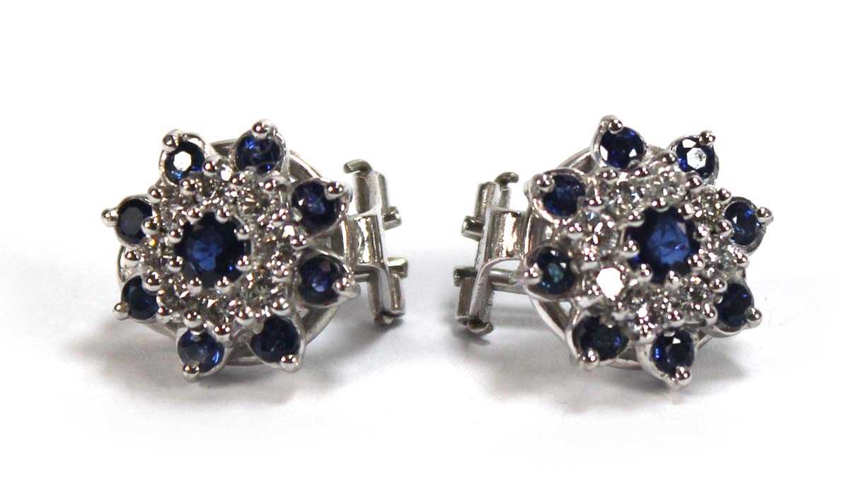 Lot 506 - A pair of 18ct white gold ear clips, each set...