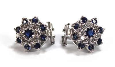 Lot 506 - A pair of 18ct white gold ear clips, each set...