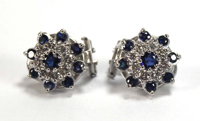 Lot 506 - A pair of 18ct white gold ear clips, each set...