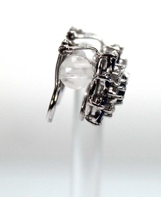 Lot 506 - A pair of 18ct white gold ear clips, each set...