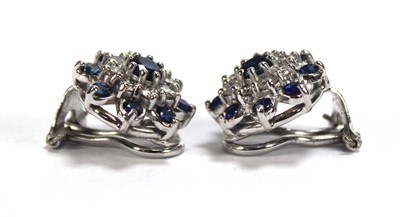 Lot 506 - A pair of 18ct white gold ear clips, each set...