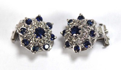 Lot 506 - A pair of 18ct white gold ear clips, each set...