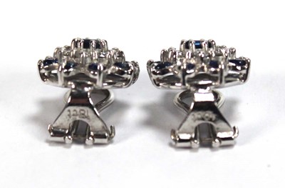 Lot 506 - A pair of 18ct white gold ear clips, each set...