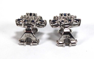 Lot 506 - A pair of 18ct white gold ear clips, each set...