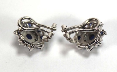 Lot 506 - A pair of 18ct white gold ear clips, each set...