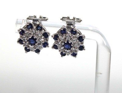 Lot 506 - A pair of 18ct white gold ear clips, each set...