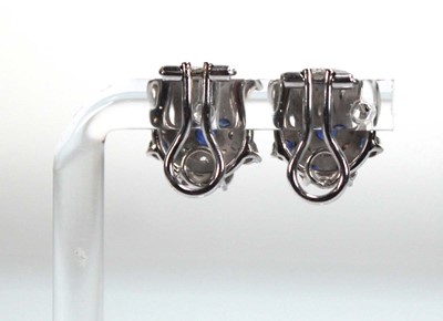Lot 506 - A pair of 18ct white gold ear clips, each set...