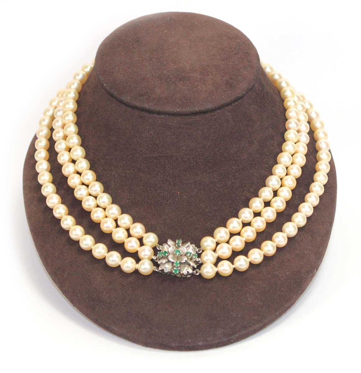 Lot 508 - A triple strand cultured pearl necklace with a...