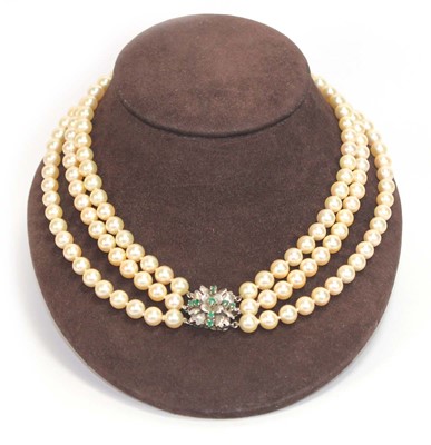 Lot 508 - A triple strand cultured pearl necklace with a...