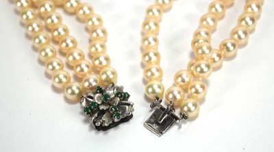 Lot 508 - A triple strand cultured pearl necklace with a...