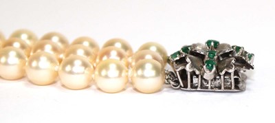 Lot 508 - A triple strand cultured pearl necklace with a...