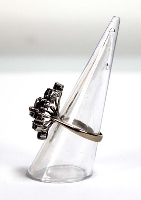 Lot 509 - A 14ct white gold cluster ring set four small...