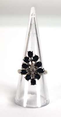 Lot 509 - A 14ct white gold cluster ring set four small...