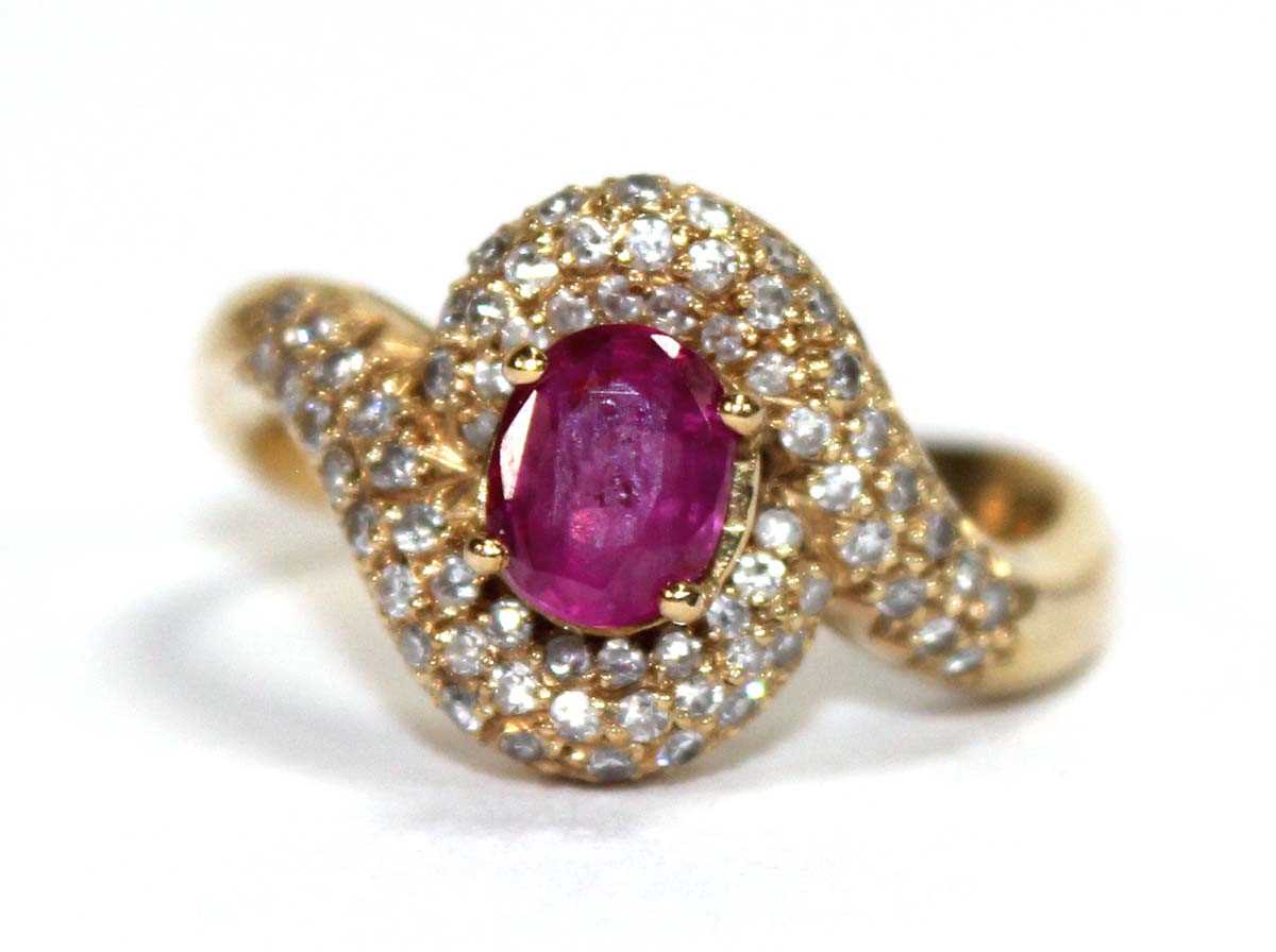 Lot 510 - An 18ct yellow gold crossover ring set oval...