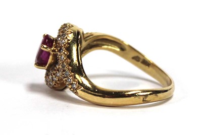 Lot 510 - An 18ct yellow gold crossover ring set oval...