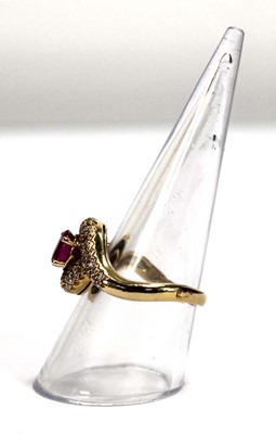 Lot 510 - An 18ct yellow gold crossover ring set oval...