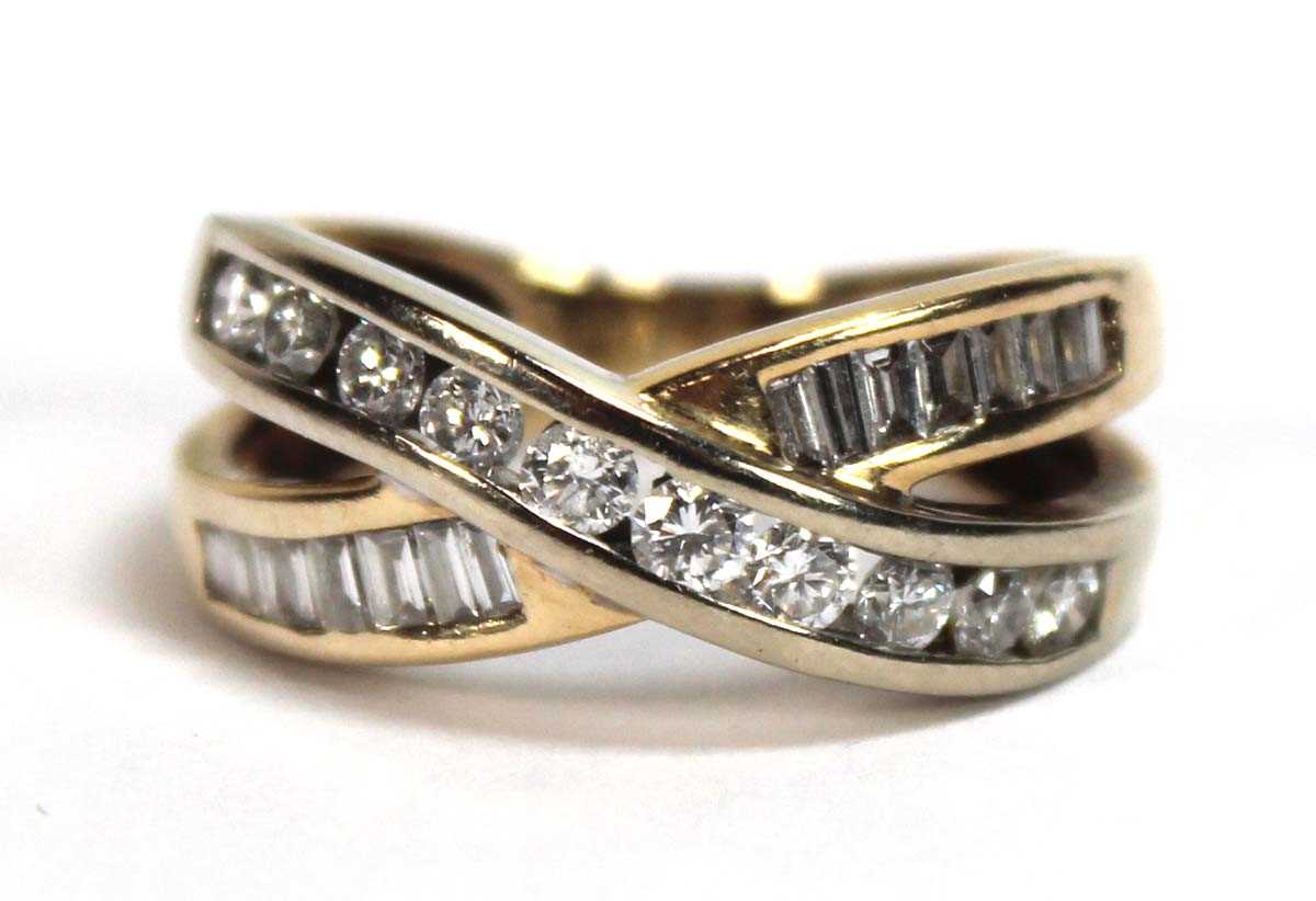 Lot 512 - A yellow metal crossover ring set two channel...
