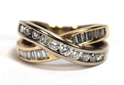 Lot 512 - A yellow metal crossover ring set two channel...