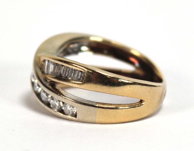 Lot 512 - A yellow metal crossover ring set two channel...