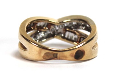 Lot 512 - A yellow metal crossover ring set two channel...