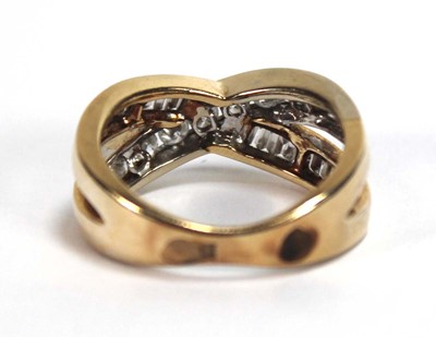 Lot 512 - A yellow metal crossover ring set two channel...