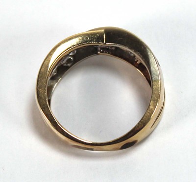 Lot 512 - A yellow metal crossover ring set two channel...