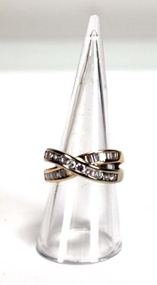 Lot 512 - A yellow metal crossover ring set two channel...