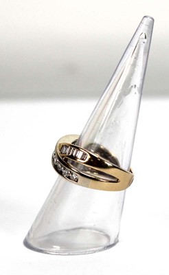 Lot 512 - A yellow metal crossover ring set two channel...