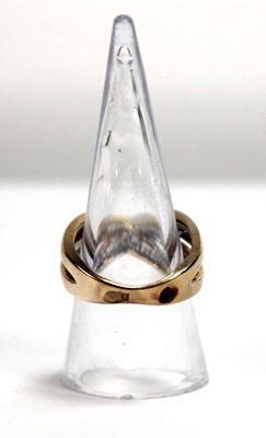 Lot 512 - A yellow metal crossover ring set two channel...