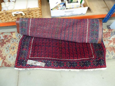 Lot 5423 - Red woollen carpet with geometric and floral...
