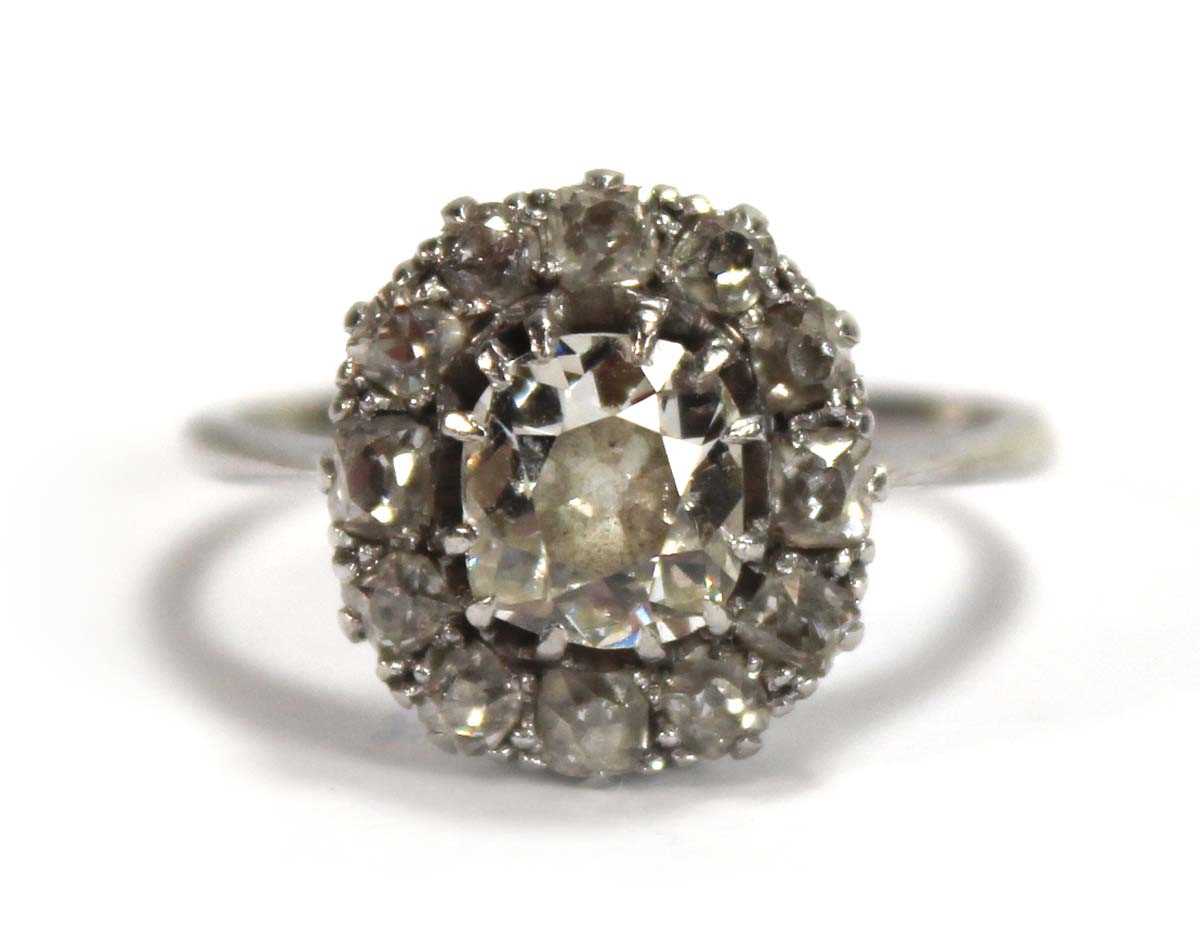 Lot 523 - An 18ct white gold cluster ring set old...