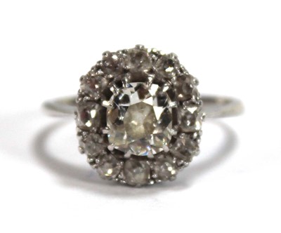 Lot 523 - An 18ct white gold cluster ring set old...