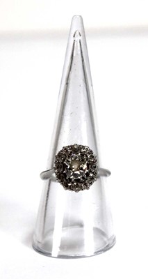 Lot 523 - An 18ct white gold cluster ring set old...