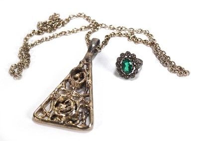 Lot 525 - A metalware dress ring set green and clear...