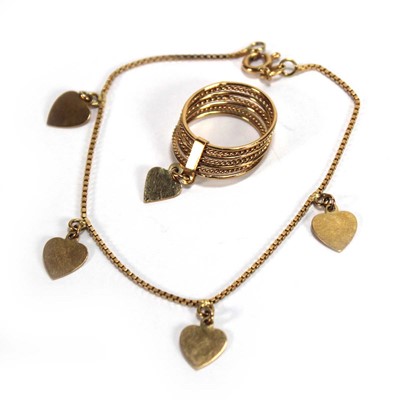 Lot 528 - An 18ct yellow gold seven band ring with heart...
