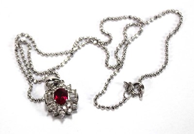 Lot 546 - An 18ct white gold cluster ring set oval ruby...