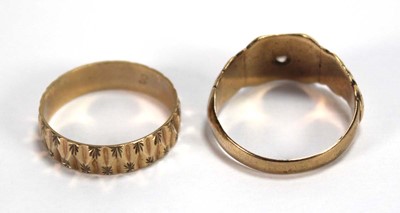 Lot 547 - A 9ct yellow gold facet cut band ring, London...