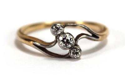 Lot 549 - An 18ct yellow gold crossover ring set three...