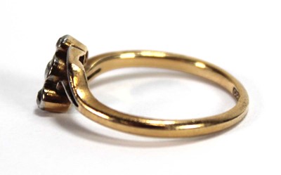 Lot 549 - An 18ct yellow gold crossover ring set three...