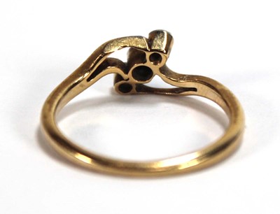 Lot 549 - An 18ct yellow gold crossover ring set three...