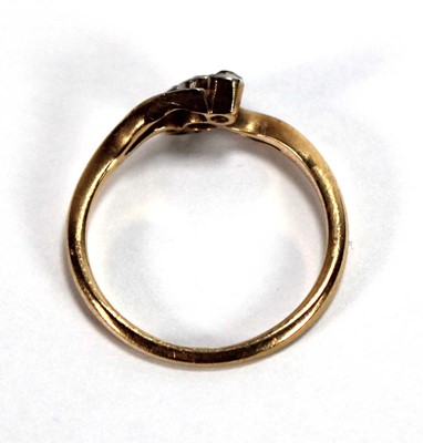 Lot 549 - An 18ct yellow gold crossover ring set three...