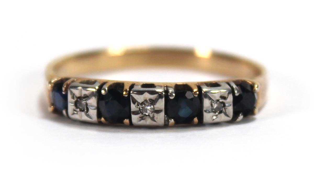 Lot 550 - A yellow metal half eternity ring set four...