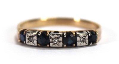 Lot 550 - A yellow metal half eternity ring set four...