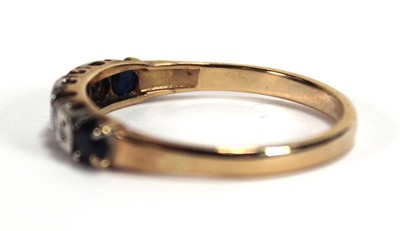 Lot 550 - A yellow metal half eternity ring set four...