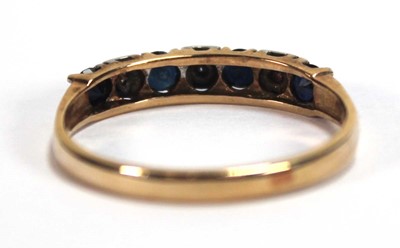 Lot 550 - A yellow metal half eternity ring set four...