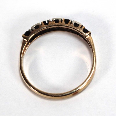 Lot 550 - A yellow metal half eternity ring set four...