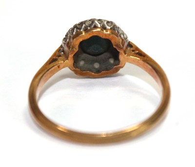 Lot 556 - An 18ct yellow gold cluster ring set round cut...